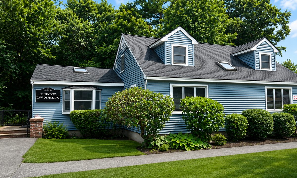 The Clermont Law Office building at 490 Textile Avenue, Dracut: a blue Cape-style house with white trim, a black sign reading Clermont Law Office, PC beside the front door, and a paved walkway from the parking area